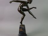 bronze statue of a woman on a marble base