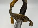 an image of a sword with a gold handle on a white background