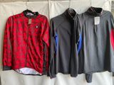 two men ' s jackets hanging on a clothes rack in front of a wall