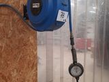 a blue air blower attached to the wall of a building