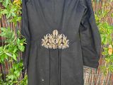 an image of a black coat with gold embroidery on it