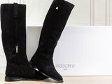 the black boots are next to a white box on the floor