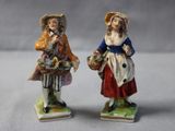 pair of figurines of two women with baskets of flowers