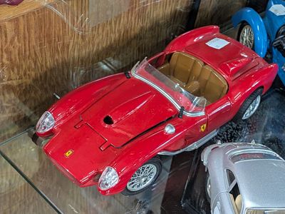 two toy cars that are on display in a glass case