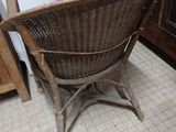 a wicker chair sitting in the corner of a kitchen