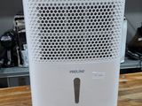 a small air purifier sitting on a wooden table