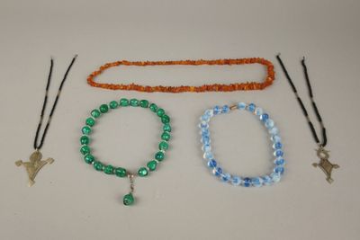 trois bracelets et un collier sont posés sur une table