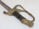 a very old sword that is laying on the table