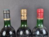 three bottles of wine are lined up on a table