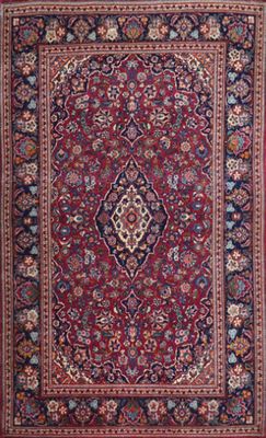 a red and blue rug with a medallion design on it