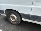 a white van with a flat tire parked in a parking lot
