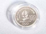 the coin is in a clear plastic container on a white surface