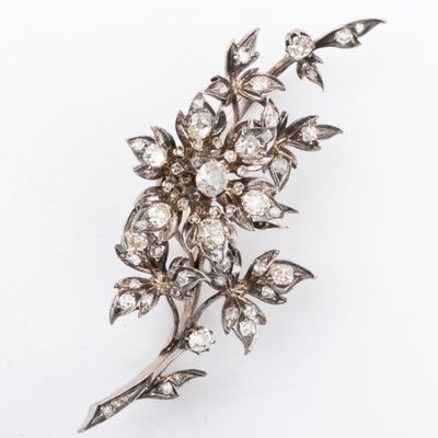 a close up of a diamond flower broochle on a white background