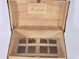 an old suitcase with a lot of compartments inside of it