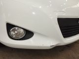 the front end of a white car is shown with the hood down