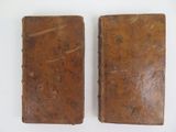 pair of antique leather bound books on a white surface