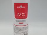 a white bottle with a red label sitting on top of a white table