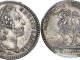 a silver coin with an image of a woman on it