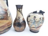 three vases with different designs on them on a white surface