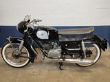 a black motorcycle parked in a garage with a blue wall
