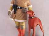 une figurine représentant un homme et un chien posée sur une table