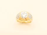a close up of a gold ring with a diamond on it