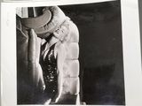 a black and white photo of a woman in a fur coat