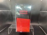 a clear display case with a red book inside of it