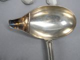 a silver spoon with a spoon rest on a table