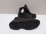pair of black hiking boots on a white surface in a room