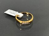 a close up of a gold ring with diamonds on a black surface