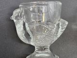 a glass cup that is sitting on a table