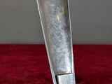 a knife that is sitting on a red surface