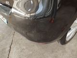 a close up of a car ' s headlight and front bumper