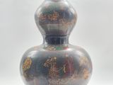a vase with a design on it sitting on a table