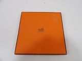 an orange box with a logo on it sitting on a white surface