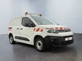 the white van is parked in a large room with a red and white stripe on the side of the van