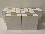 six boxes of white toilet paper sitting on top of a white table