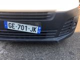 a white van with a blue license plate on the front of it