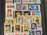 a person holding a book with a lot of stamps on it