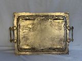 an antique brass tray with handles and handles on a white background