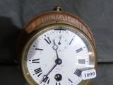 a wooden clock with roman numerals on the face