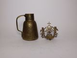 an image of a small brass pitcher next to a small brass candle holder