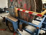 an image of a large wooden cable reel on a trailer