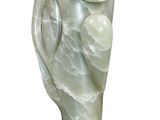 statue of a woman holding a baby elephant on a wooden base