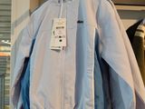 two jackets hanging on a rack in a store