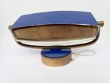a blue and gold purse on a blue stand