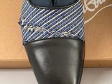 black leather shoes with a blue and white pattern on the sole