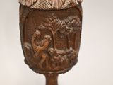 a wooden cup with a picture of a man and a woman on it