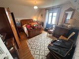 a bedroom with a bed, dresser, and a chair in it